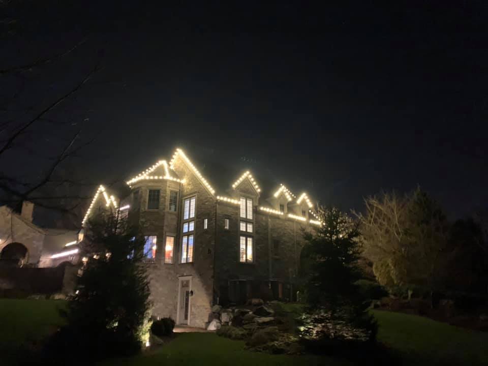 large house with lights strung around it